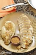 Plate with seasoned and browned chicken breasts.