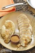 Plate with seasoned and browned chicken breasts. 