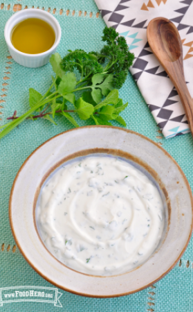 Small bowl of a creamy, white sauce. 