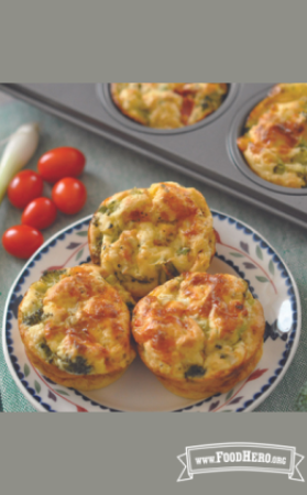 Plate of golden baked egg, vegetable and cheese quiches. 