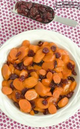 Tender carrot slices with dried cranberries in a small bowl.