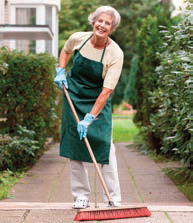 older woman sweeping