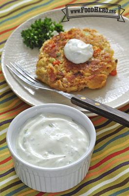 Small bowl of tartar sauce with a vegetable patty. 