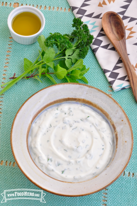 Small bowl of a creamy, white sauce. 