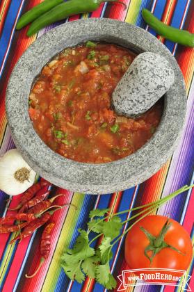 Bowl of textured tomato salsa.