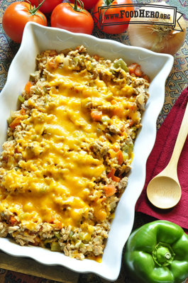 Casserole dish with rice, beef and vegetables with melted cheddar cheese. 