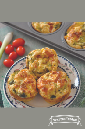 Plate of golden baked egg, vegetable and cheese quiches.