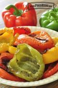 Multicolored bell pepper halves with blistered skin in a bowl. 