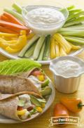 Yogurt dip served in a veggie wrap and sliced vegetables.