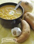 Bowl of orange, creamy soup with a dallop of sour cream