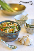 Bowl of ramen noodles and vegetables shown with a renge spoon.