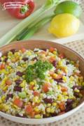 Bowl of barley, bean and vegetable salad garnished with parsley.