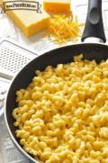 Skillet with cheesy macaroni noodles.