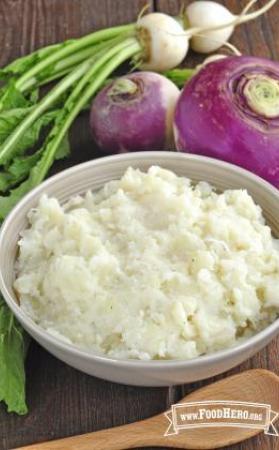 Bowl of seasoned and mashed potatoes and turnips.
