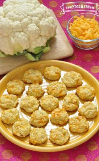 Baked rounds of chopped cauliflower and cheese are shown on a platter.
