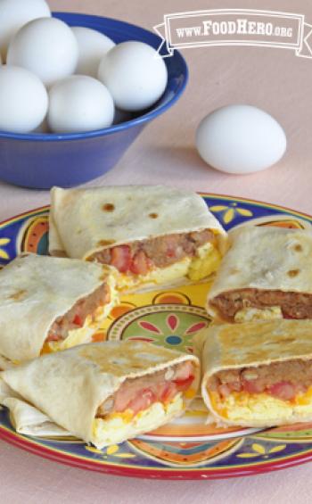 Flour tortillas are filled with beans, eggs, tomato and cheese and baked for a crispy outside.