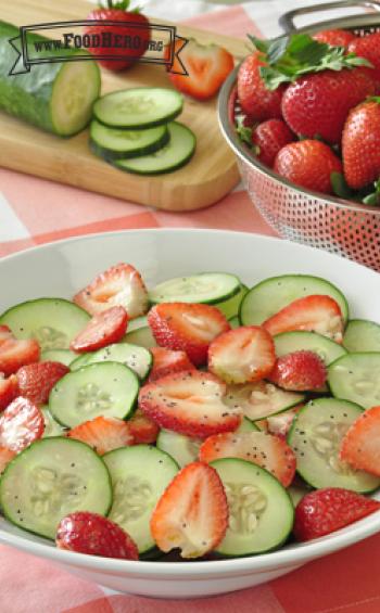 Strawberry and cucumber slices coated with poppy seed dressing.